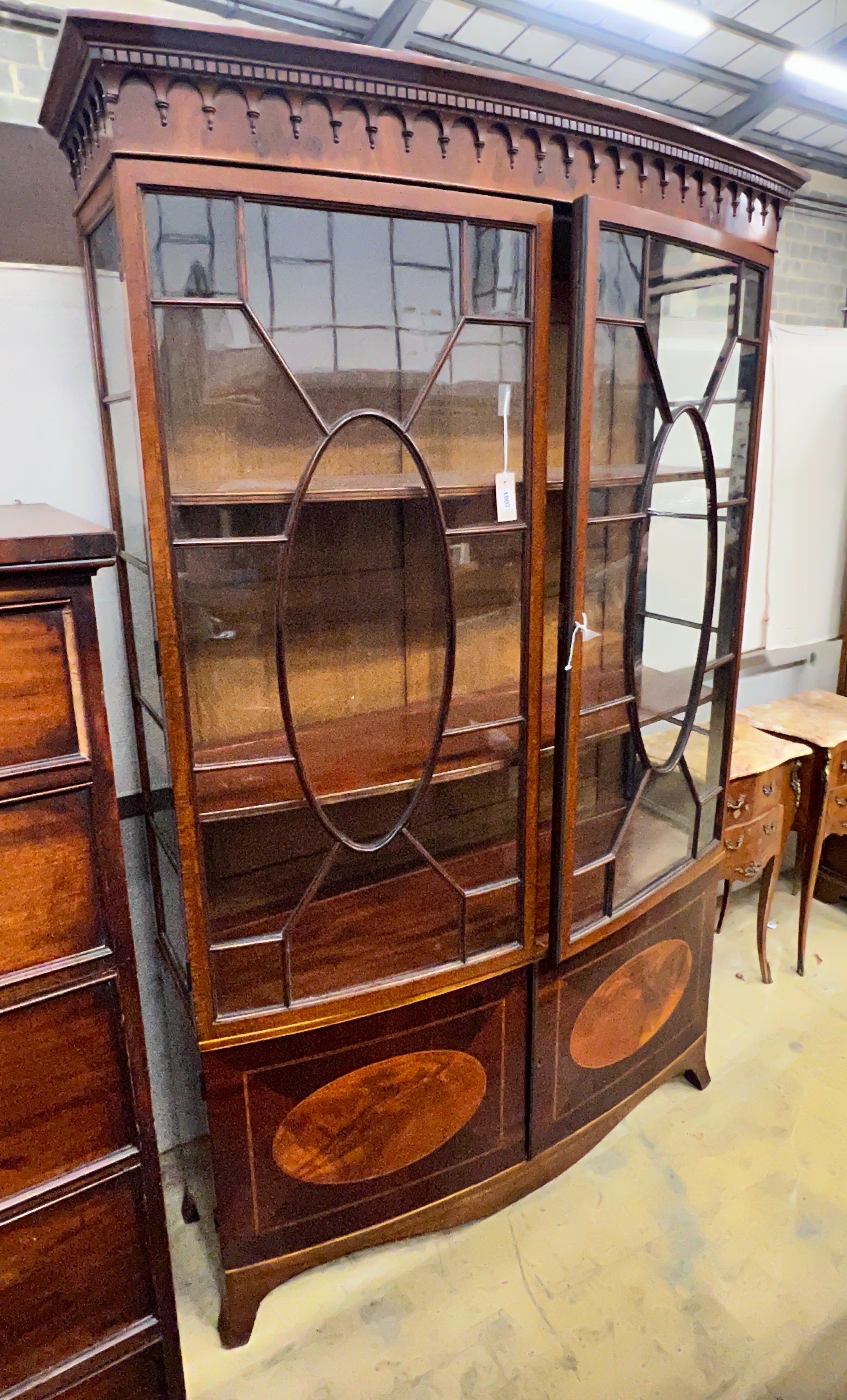 An early 20th century George III style satinwood banded mahogany inlaid bow front display cabinet, width 128cm, depth 40cm, height 197cm